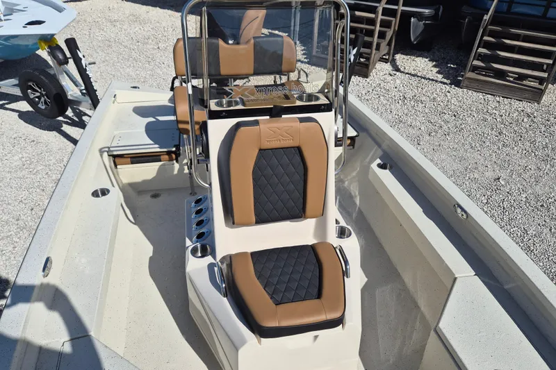 Slide: The Image of 2026 Xpress H20B Bay boat interior with tan and black seating, showcasing modern design. - 15