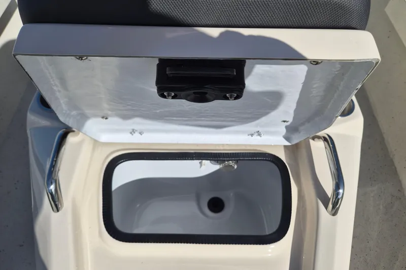 Slide: The Image of Open storage compartment on 2026 Xpress H20B Bay boat, featuring stainless steel handles. - 16