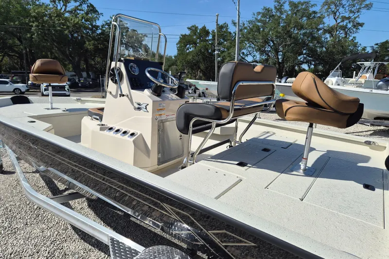 Slide: The Image of 2026 Xpress H20B Bay boat with seating and console, parked outdoors. - 4