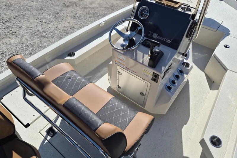 Slide: The Image of 2026 Xpress H20B Bay boat interior with steering console and cushioned seating. - 7
