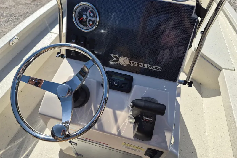 Slide: The Image of Steering console of 2026 Xpress H20B Bay boat with chrome wheel and Yamaha controls. - 8