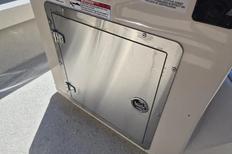 Slide: The Image of Stainless steel hatch on 2026 Xpress H20B Bay boat, featuring safety warning label. - 9