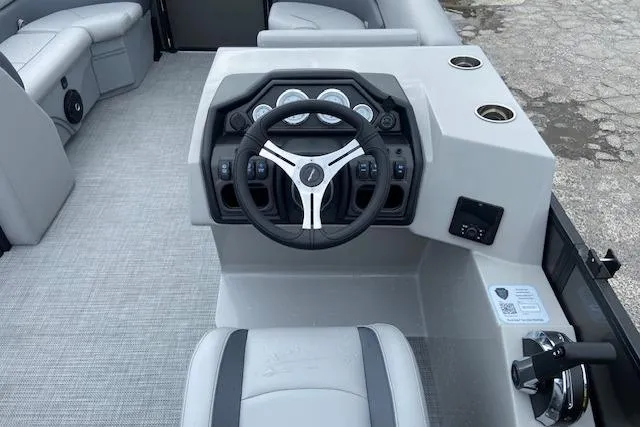 Slide: The Image of 2025 Bentley Pontoons Legacy 220 Navigator dashboard with steering wheel and controls. - 3