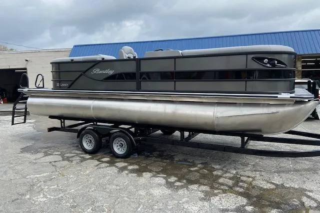 Slide: The Image of Bentley Pontoons Legacy 220 Navigator 2025 on trailer, parked outdoors. - 7