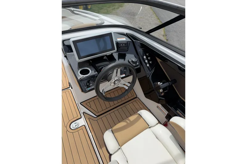 Slide: The Image of Interior cockpit of 2022 Yamaha Boats 252SE, featuring modern steering and control panel. - 4