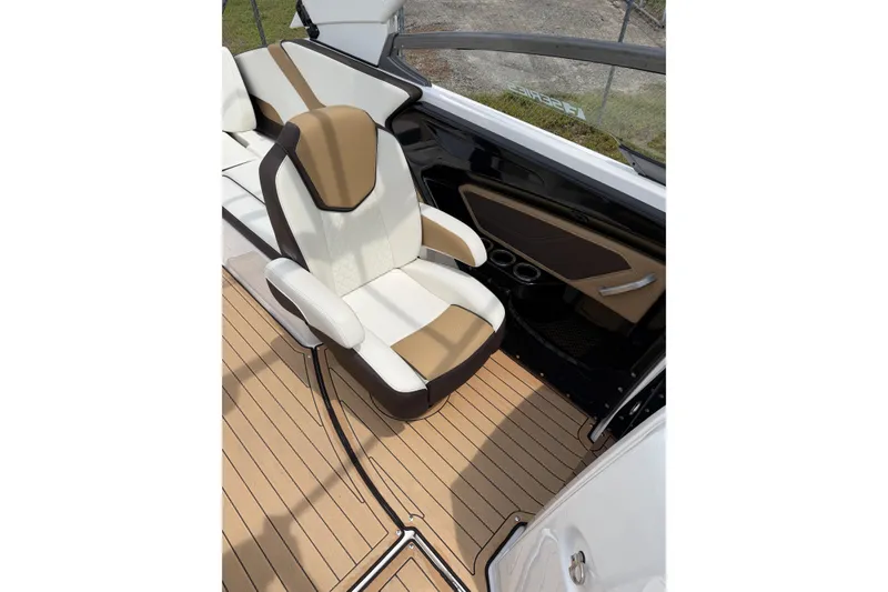 Slide: The Image of 2022 Yamaha Boats 252SE interior with tan and white seating, sleek design, and wood-style flooring. - 5