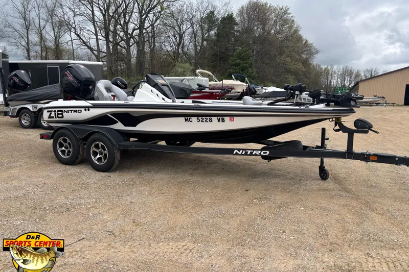 The Image of 2024 Nitro Z18 boat on trailer in outdoor setting, featuring sleek design and dual motors. - 1