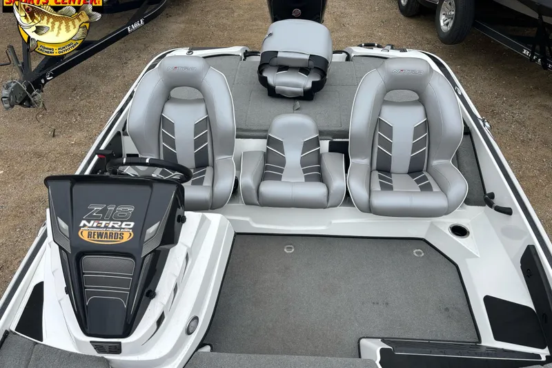 Slide: The Image of 2024 Nitro Z18 boat interior with gray seating and steering console. - 12