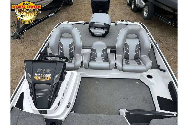Slide: The Image of 2024 Nitro Z18 boat interior with gray seating and steering console. - 9