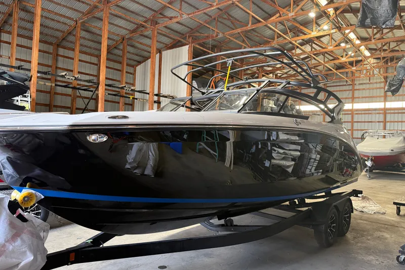 The Image of 2026 Yamaha Boats 252SD in a spacious indoor storage facility. - 0