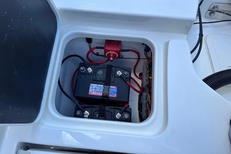 Slide: The Image of Battery compartment of 2026 Key West 230 Bay Reef boat, showing wiring and connections. - 13