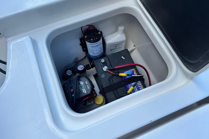 Slide: The Image of Battery compartment of 2026 Key West 230 Bay Reef boat with wiring and accessories. - 14