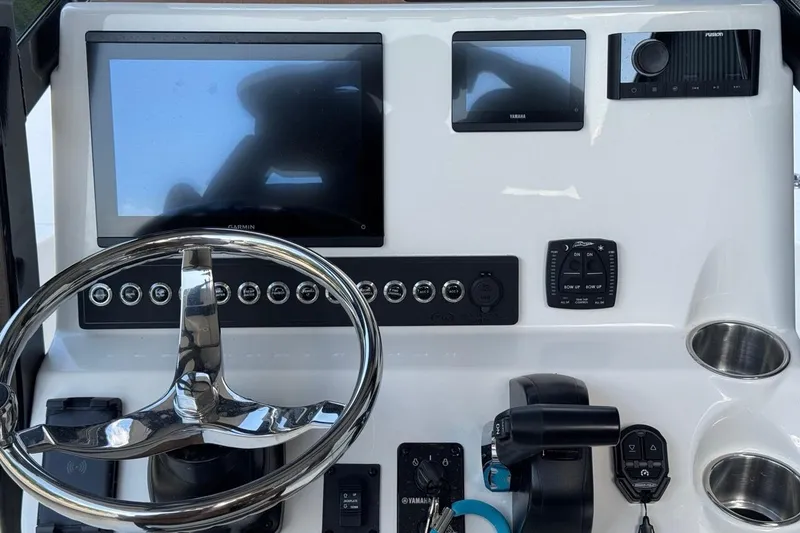 Slide: The Image of Dashboard of 2026 Key West 230 Bay Reef boat with steering wheel and electronic displays. - 15
