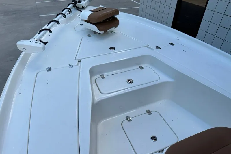 Slide: The Image of 2026 Key West 230 Bay Reef boat deck with storage compartments and Garmin equipment. - 16