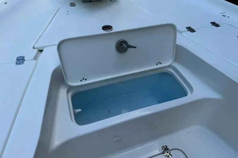 Slide: The Image of 2026 Key West 230 Bay Reef boat livewell with open lid, showcasing interior. - 18