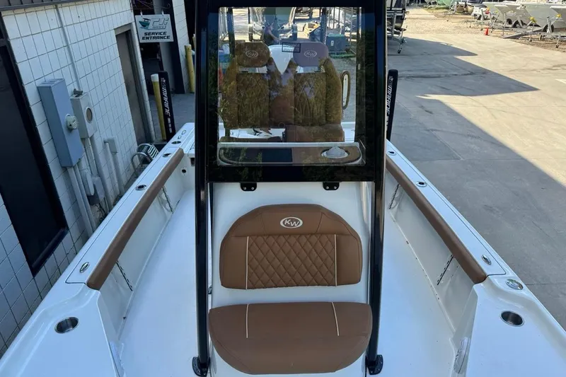 Slide: The Image of 2026 Key West 230 Bay Reef boat with brown seating and sleek design. - 23