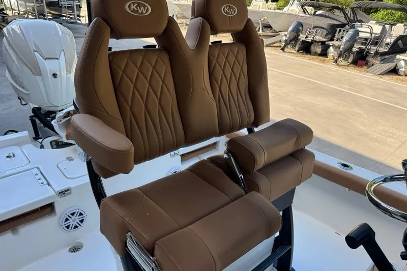 Slide: The Image of 2026 Key West 230 Bay Reef boat with brown leather seating and modern design. - 24