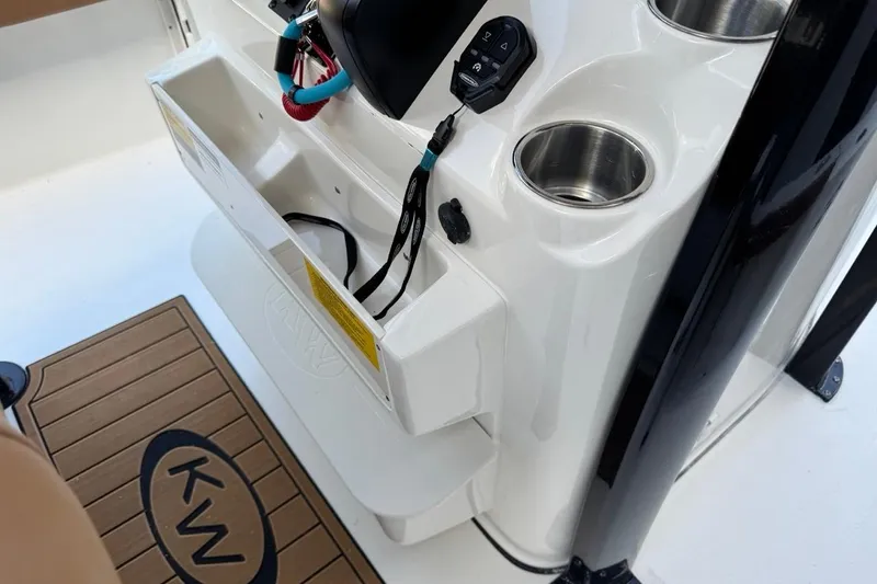 Slide: The Image of 2026 Key West 230 Bay Reef boat console with cup holders and storage compartment. - 25