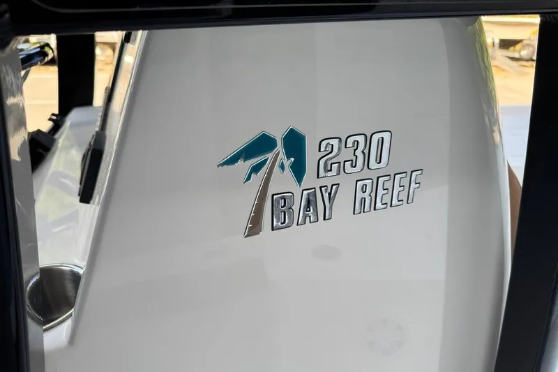 Slide: The Image of 2026 Key West 230 Bay Reef boat logo on white surface. - 26