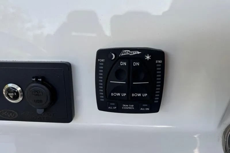 Slide: The Image of Control panel on 2026 Key West 230 Bay Reef boat with USB and trim tab controls. - 28