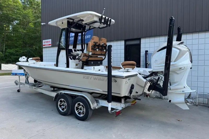 Slide: The Image of 2026 Key West 230 Bay Reef boat on trailer, parked outdoors near a building. - 3