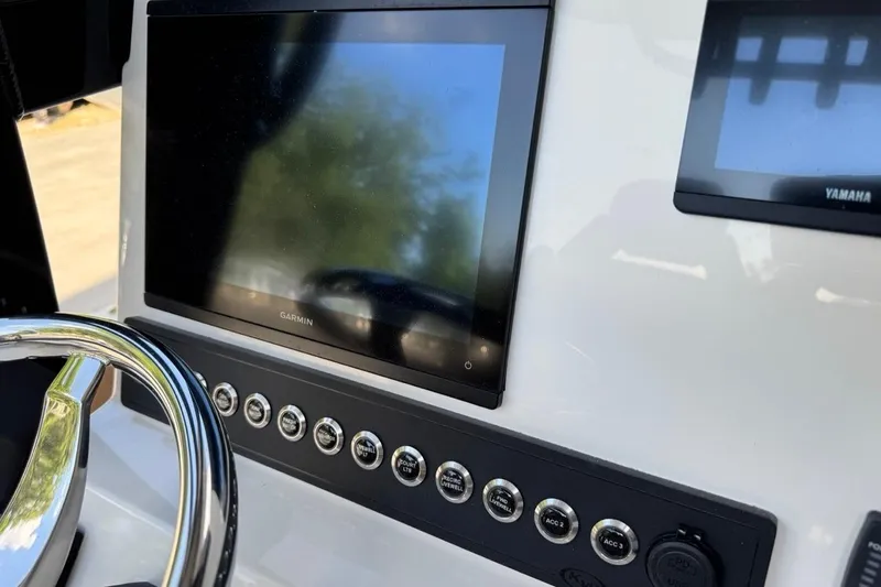 Slide: The Image of Dashboard of 2026 Key West 230 Bay Reef boat with Garmin display and controls. - 30