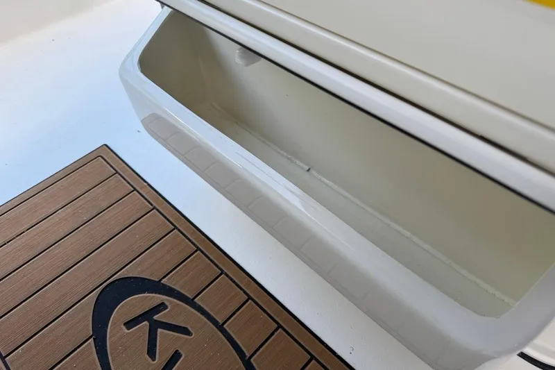 Slide: The Image of Key West 230 Bay Reef 2026 boat storage compartment and deck mat detail. - 31