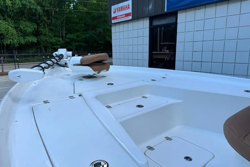 Slide: The Image of 2026 Key West 230 Bay Reef boat deck near Yamaha dealership, featuring seating and storage compartments. - 9