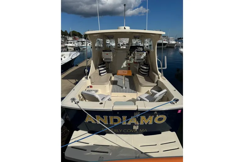 Slide: The Image of 2004 Mainship Pilot 30-II boat docked, featuring spacious seating and nautical decor. - 17