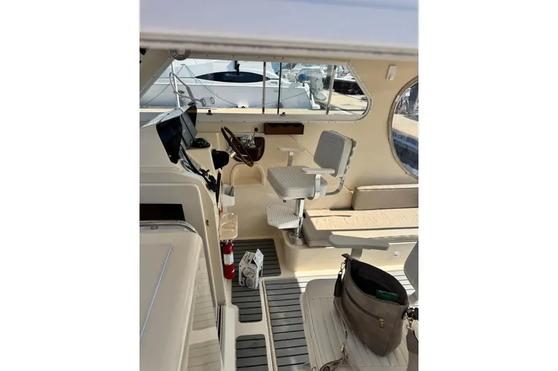 Slide: The Image of 2004 Mainship Pilot 30-II boat interior with helm, seating, and nautical equipment. - 21