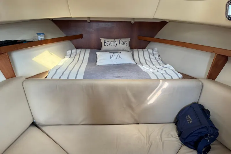 Slide: The Image of Cozy cabin interior of 2004 Mainship Pilot 30-II with striped bedding and cushions. - 25