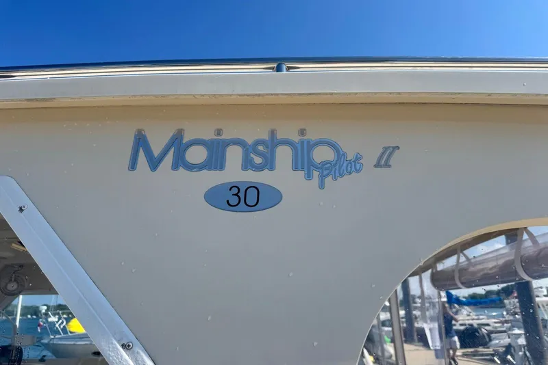 Slide: The Image of 2004 Mainship Pilot 30-II boat side view with logo and model name. - 29