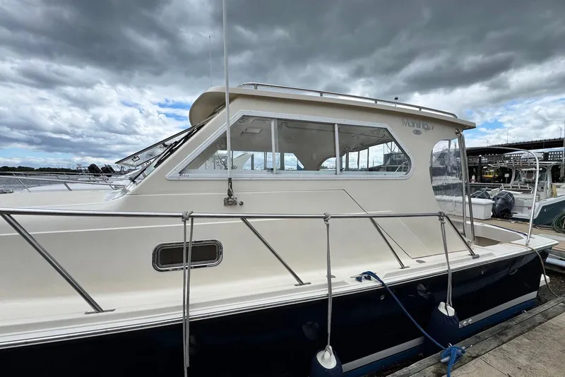 Slide: The Image of 2004 Mainship Pilot 30-II boat docked under cloudy skies. - 4