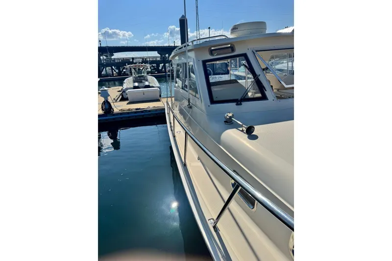 Slide: The Image of 2004 Mainship Pilot 30-II docked at marina, sunny day, calm waters. - 8