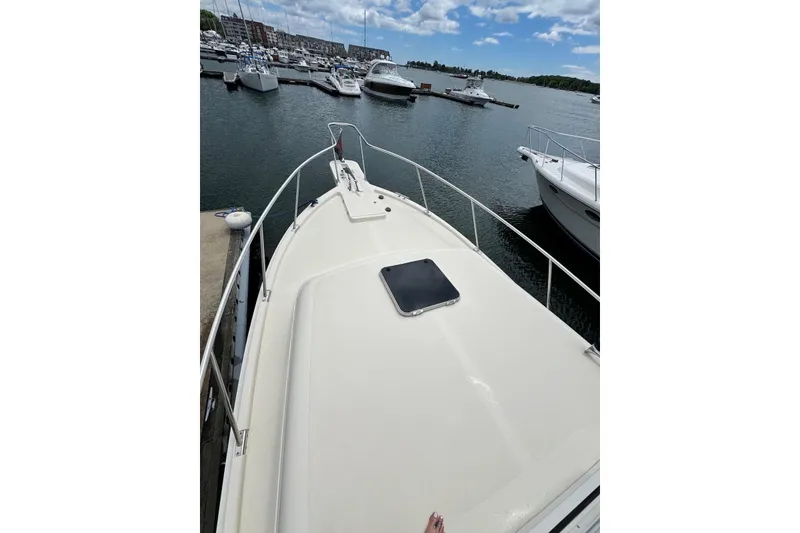 Slide: The Image of 2004 Mainship Pilot 30-II docked at marina, surrounded by other boats. - 9
