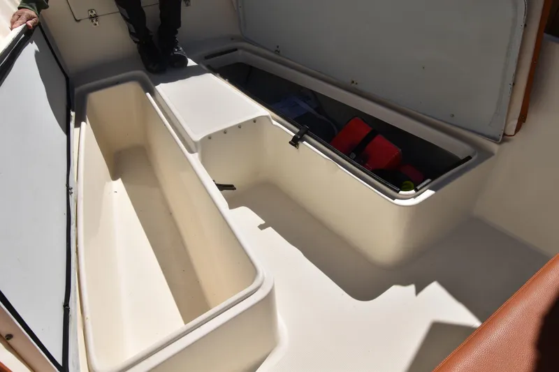 Slide: The Image of Open storage compartments on a 2001 Pursuit 2470 Center Console boat. - 10