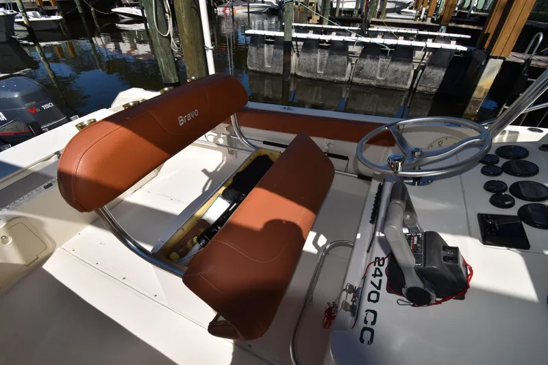 Slide: The Image of 2001 Pursuit 2470 Center Console boat interior with steering wheel and seating. - 12