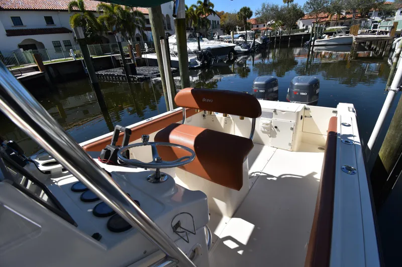 Slide: The Image of 2001 Pursuit 2470 Center Console boat docked, featuring dual Yamaha V6 150 engines. - 13