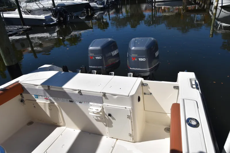 Slide: The Image of 2001 Pursuit 2470 Center Console boat with twin Yamaha V6 150 engines docked. - 14