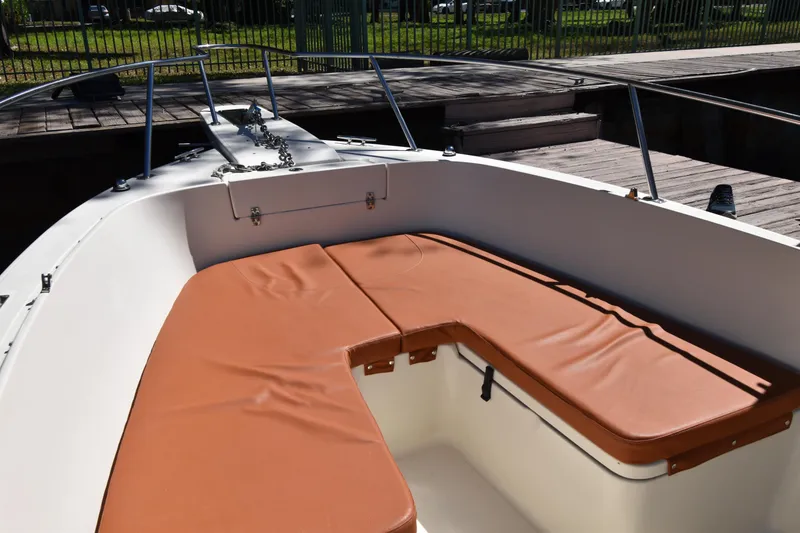 Slide: The Image of 2001 Pursuit 2470 Center Console boat with tan cushioned seating at the bow. - 16