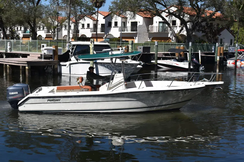 Slide: The Image of 2001 Pursuit 2470 Center Console boat docked in a marina with Yamaha engine. - 4