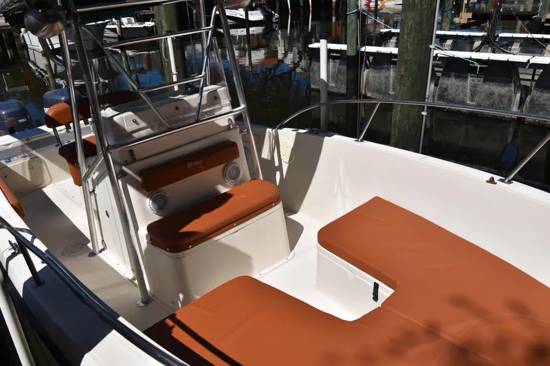 Slide: The Image of 2001 Pursuit 2470 Center Console boat with brown seating, docked in marina. - 5