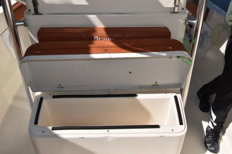 Slide: The Image of Open storage compartment on a 2001 Pursuit 2470 Center Console boat. - 8