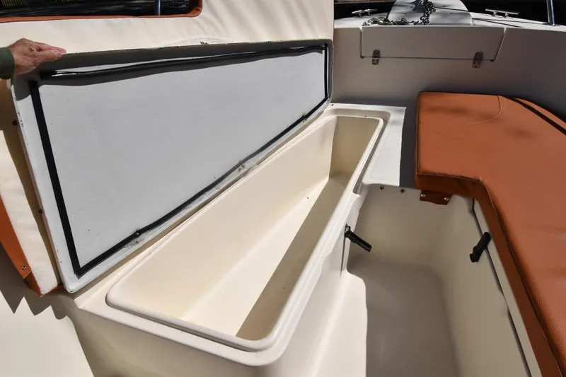Slide: The Image of Open storage compartment on a 2001 Pursuit 2470 Center Console boat. - 9