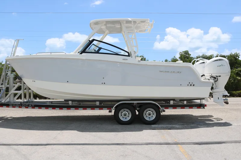 The Image of 2026 World Cat 265 DC-X boat on trailer, clear sky background. - 0