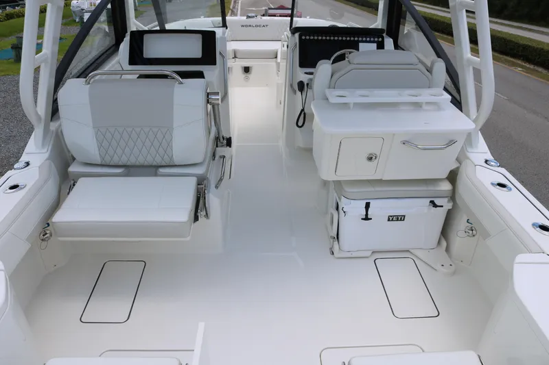 Slide: The Image of 2026 World Cat 265 DC-X boat interior with seating, storage, and Yeti cooler. - 15
