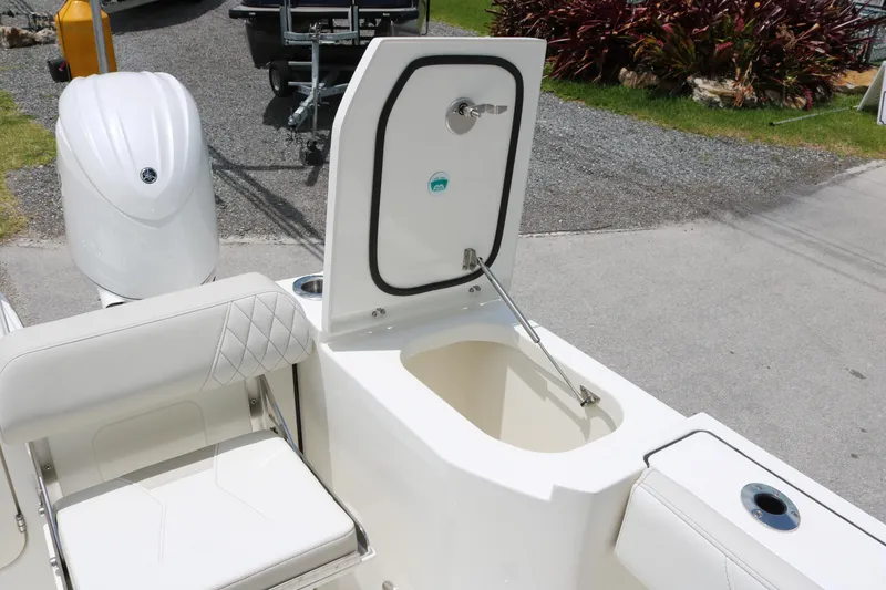 Slide: The Image of 2026 World Cat 265 DC-X boat with open storage compartment and seating. - 17