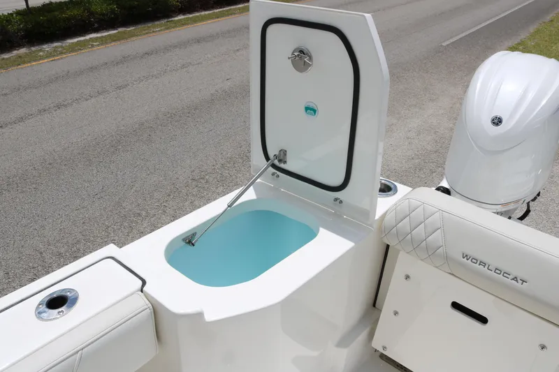 Slide: The Image of 2026 World Cat 265 DC-X boat with open storage compartment and visible engine. - 18