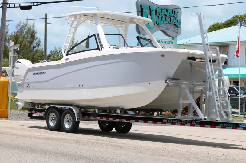 Slide: The Image of 2026 World Cat 265 DC-X boat on trailer at Unique Marine dealership. - 2