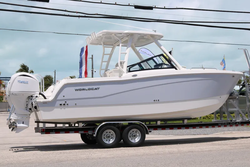 Slide: The Image of 2026 World Cat 265 DC-X boat on trailer with Yamaha engine, outdoor display. - 3